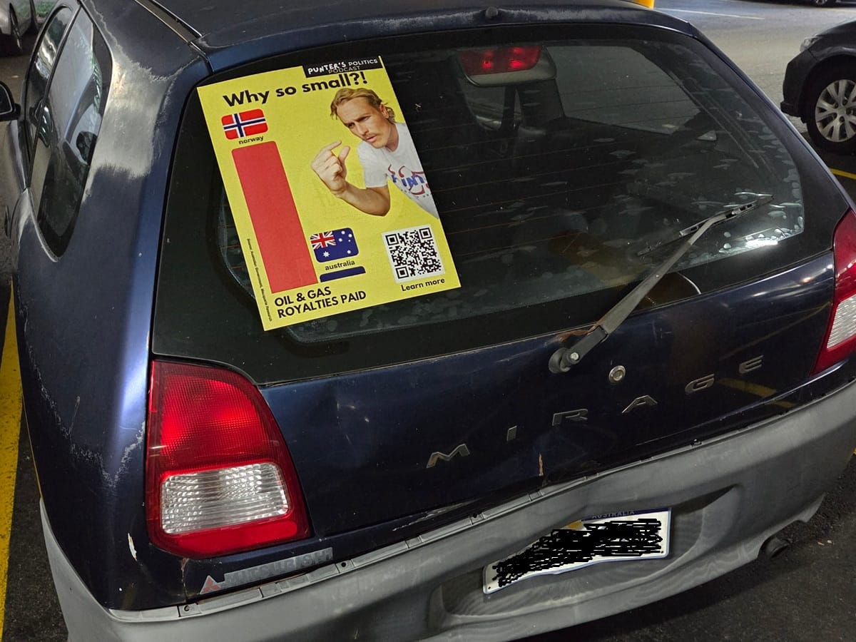 Anti-gas propaganda on the back of a dinged up car.